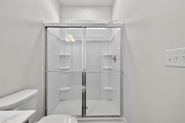 a bathroom with a glass shower door
