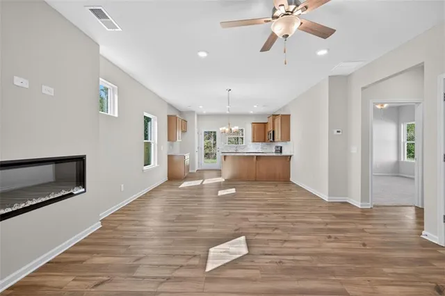 a view of a livingroom with a hall and wooden floor