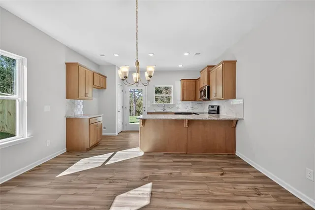 a large kitchen with granite countertop a window and a sink