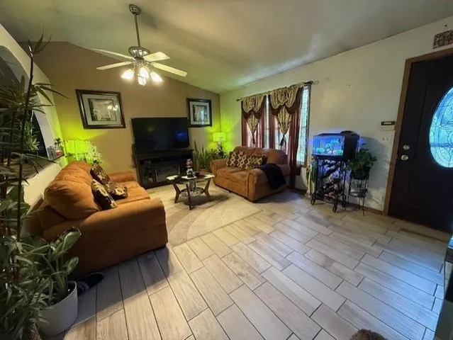 a living room with furniture and a flat screen tv