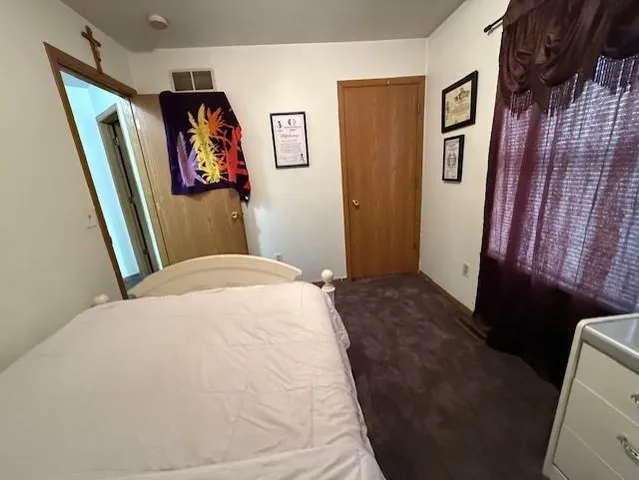 a bedroom with a bed and a mirror