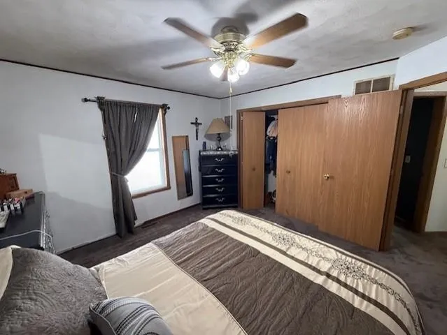 a bedroom with a large bed and a window