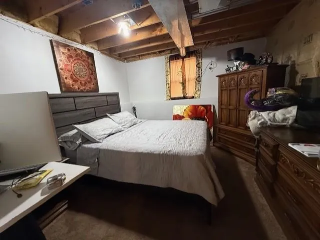 a bedroom with furniture and a window