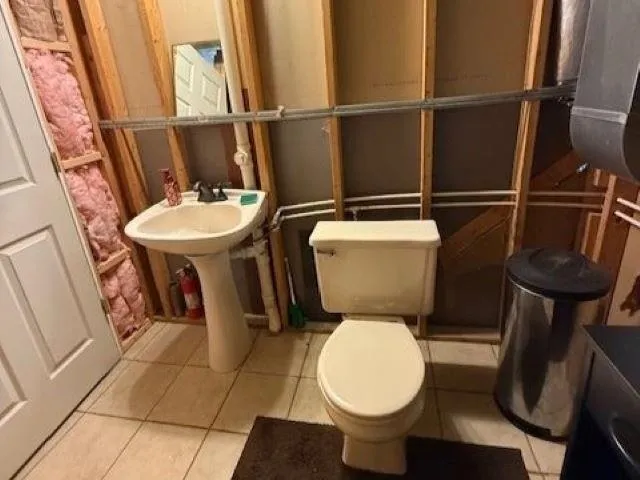 a bathroom with a toilet and a sink