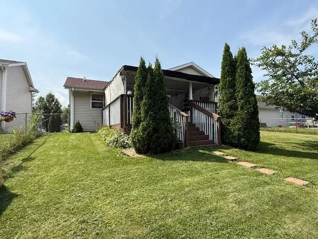 a view of a house with a yard and pathway