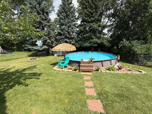 a small pool with a table and chairs