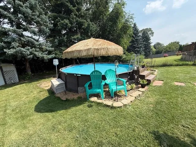 a view of a garden with a table and chairs under an umbrella