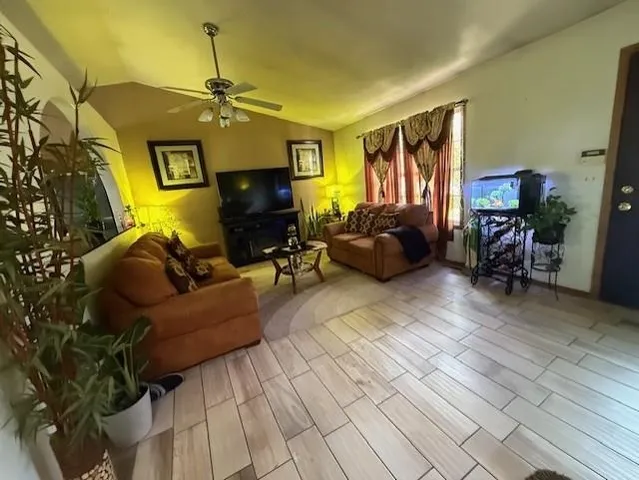 a living room with furniture and a flat screen tv