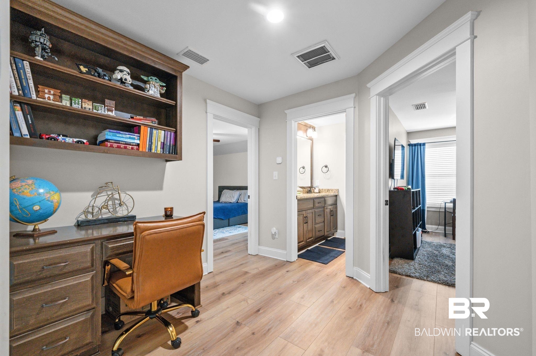 409 Fortune Drive Fairhope, AL 36532 - Photo 26 of 42 Integrated desk with built-in shelving, light wood-finish flooring, and white trim throughout