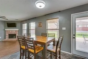 a living room with furniture a fireplace and a window