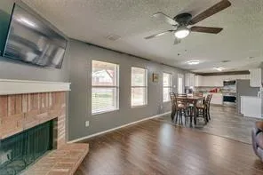 a view of a livingroom with furniture hardwood floor and a ceiling fan