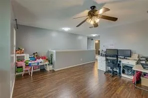 a spacious bedroom with a bed and wooden floor