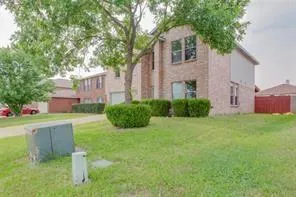 a front view of a house with a garden and plants
