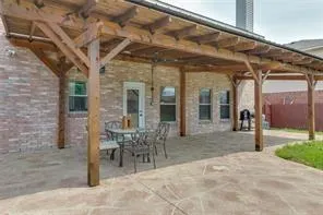 a view of a house with a yard and sitting area