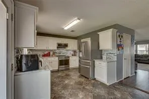 a kitchen with a stove and a white cabinet