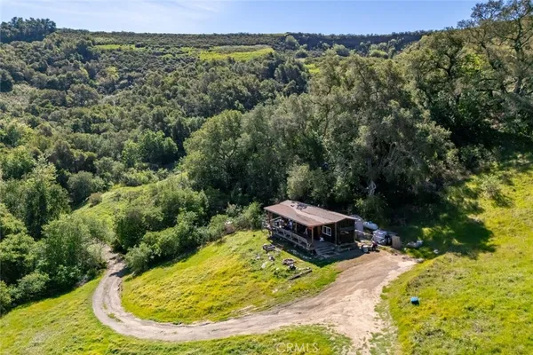 an aerial view of a residential houses with outdoor space
