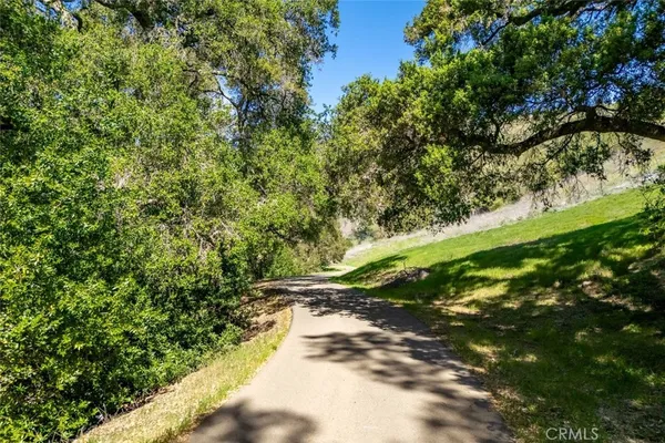 an aerial view of a house with a mountain