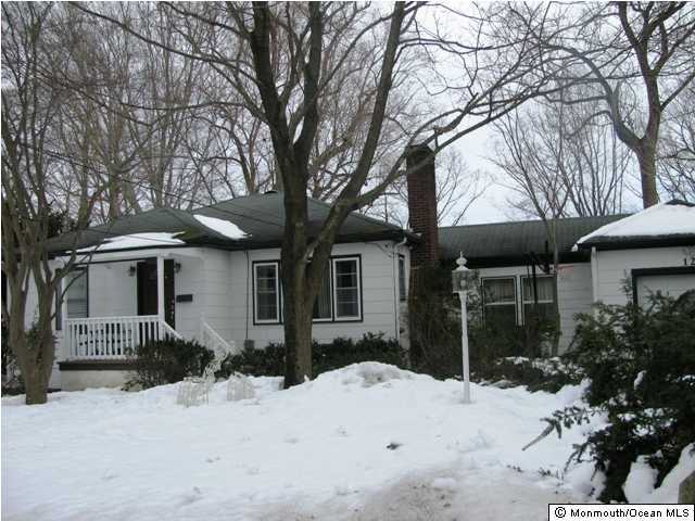 129 Pond Road Freehold, NJ 07728 - Photo 1 of 3 a front view of a house with a yard and garage