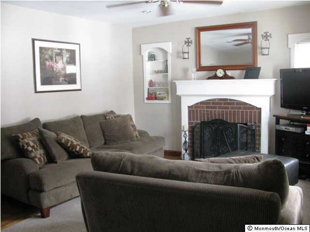 129 Pond Road Freehold, NJ 07728 - Photo 2 of 3 a living room with furniture and a flat screen tv