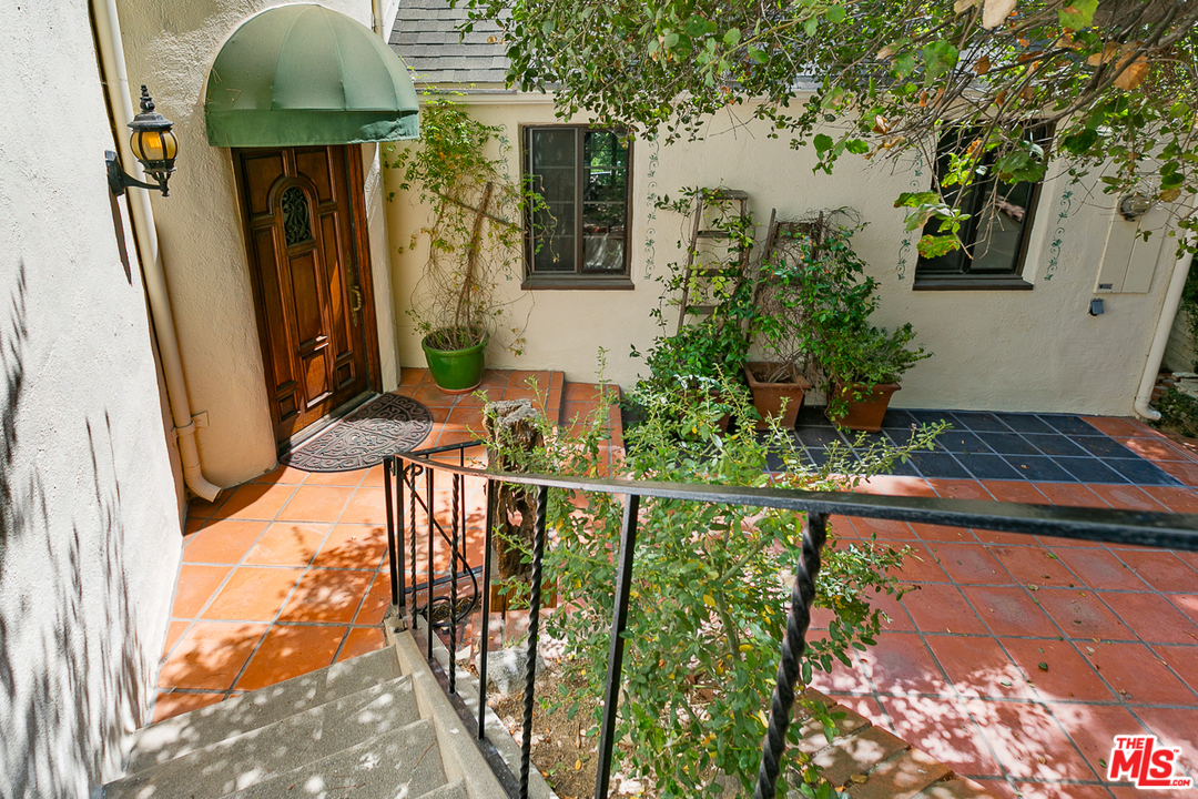 4458 Dundee Drive Los Angeles, CA 90027 - Photo 19 of 20 a front view of a house with wooden fence