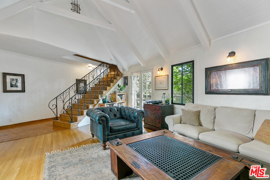 4458 Dundee Drive Los Angeles, CA 90027 - Photo 3 of 20 a living room with furniture and a floor to ceiling window