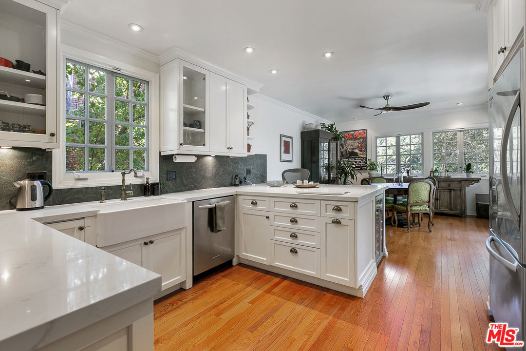 4458 Dundee Drive Los Angeles, CA 90027 - Photo 4 of 20 a kitchen with stainless steel appliances sink cabinets and wooden floor