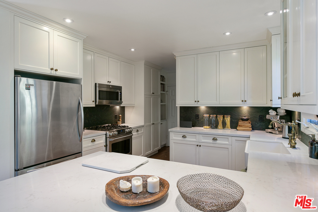 4458 Dundee Drive Los Angeles, CA 90027 - Photo 6 of 20 a kitchen with a sink a stove and refrigerator