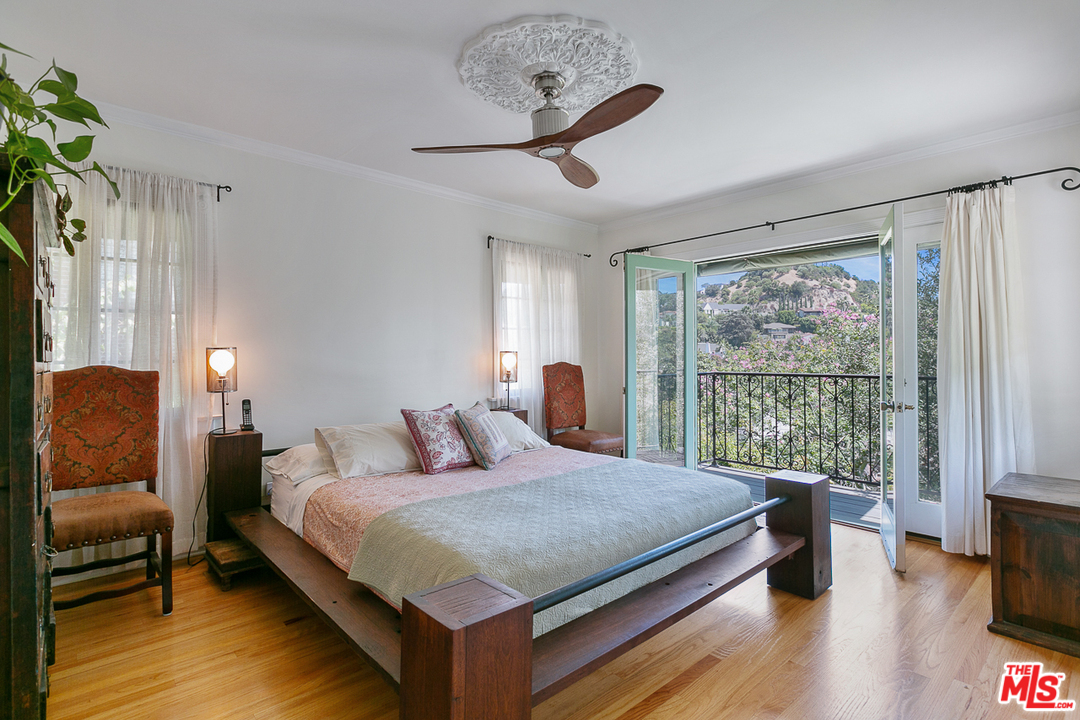 4458 Dundee Drive Los Angeles, CA 90027 - Photo 8 of 20 a bedroom with a large bed and a window