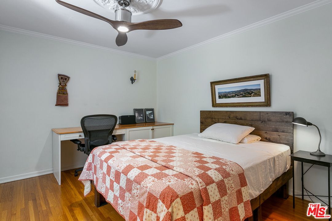 4458 Dundee Drive Los Angeles, CA 90027 - Photo 9 of 20 a bedroom with a bed a desk and chair