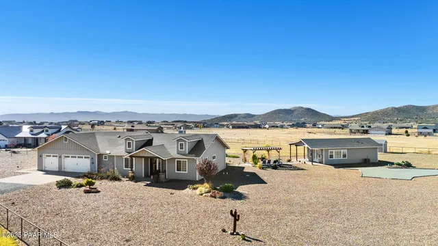 a living room with furniture a flat screen tv and kitchen view