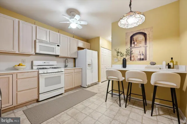 a kitchen with a cabinets and chairs