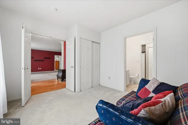 a living room with furniture and a mirror