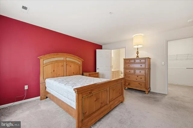 a bedroom with a bed and dresser