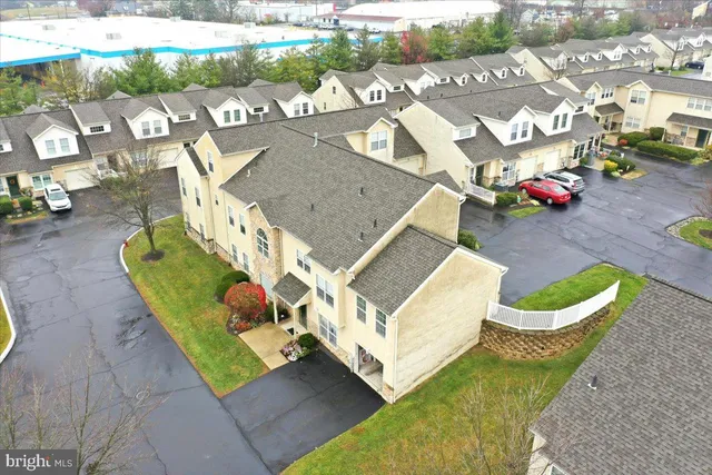an aerial view of a house with garden space and outdoor seating
