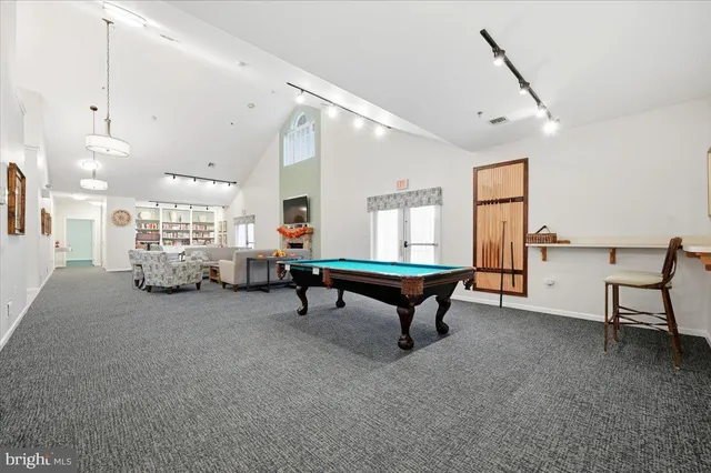a room with furniture and pool table