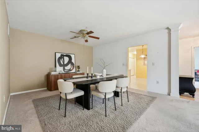 a view of a a dining room with a table and chairs