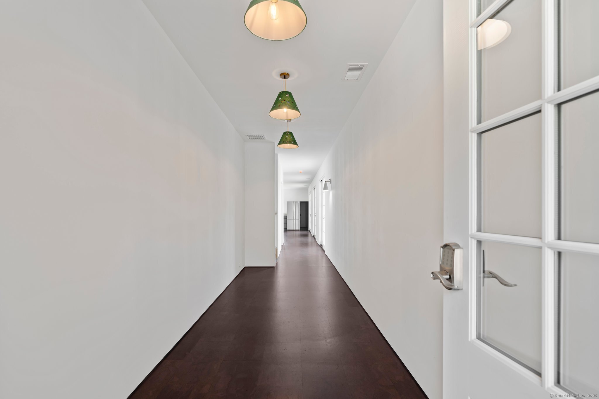 a view of a hallway with wooden floor