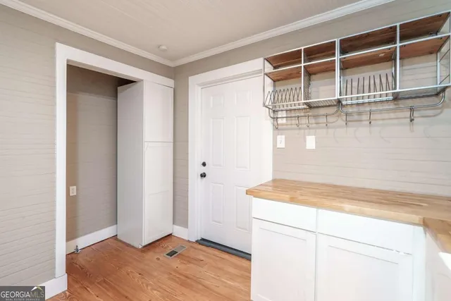 a view of a room with wooden floor and cabinet