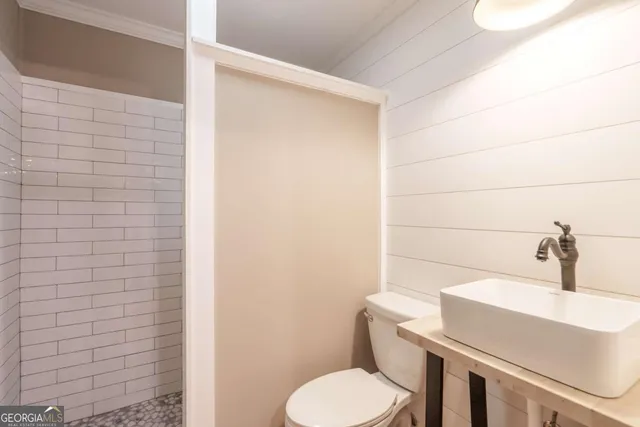 a bathroom with a sink a toilet and mirror