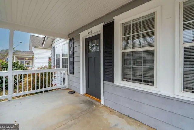 a view of a balcony with a floor to ceiling window and stairs