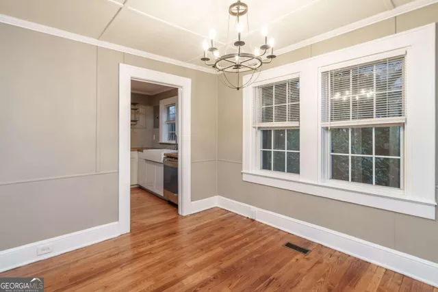 a view of a room with wooden floor and windows