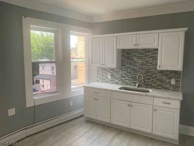 a bathroom with a sink a mirror and a window