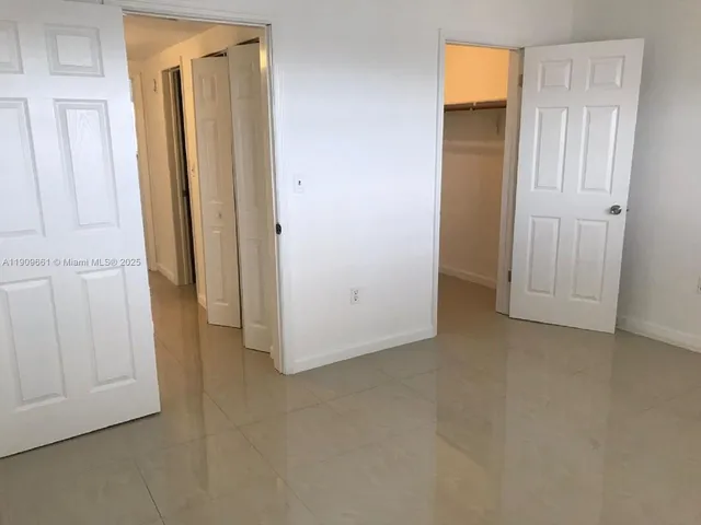 an empty room with closet area