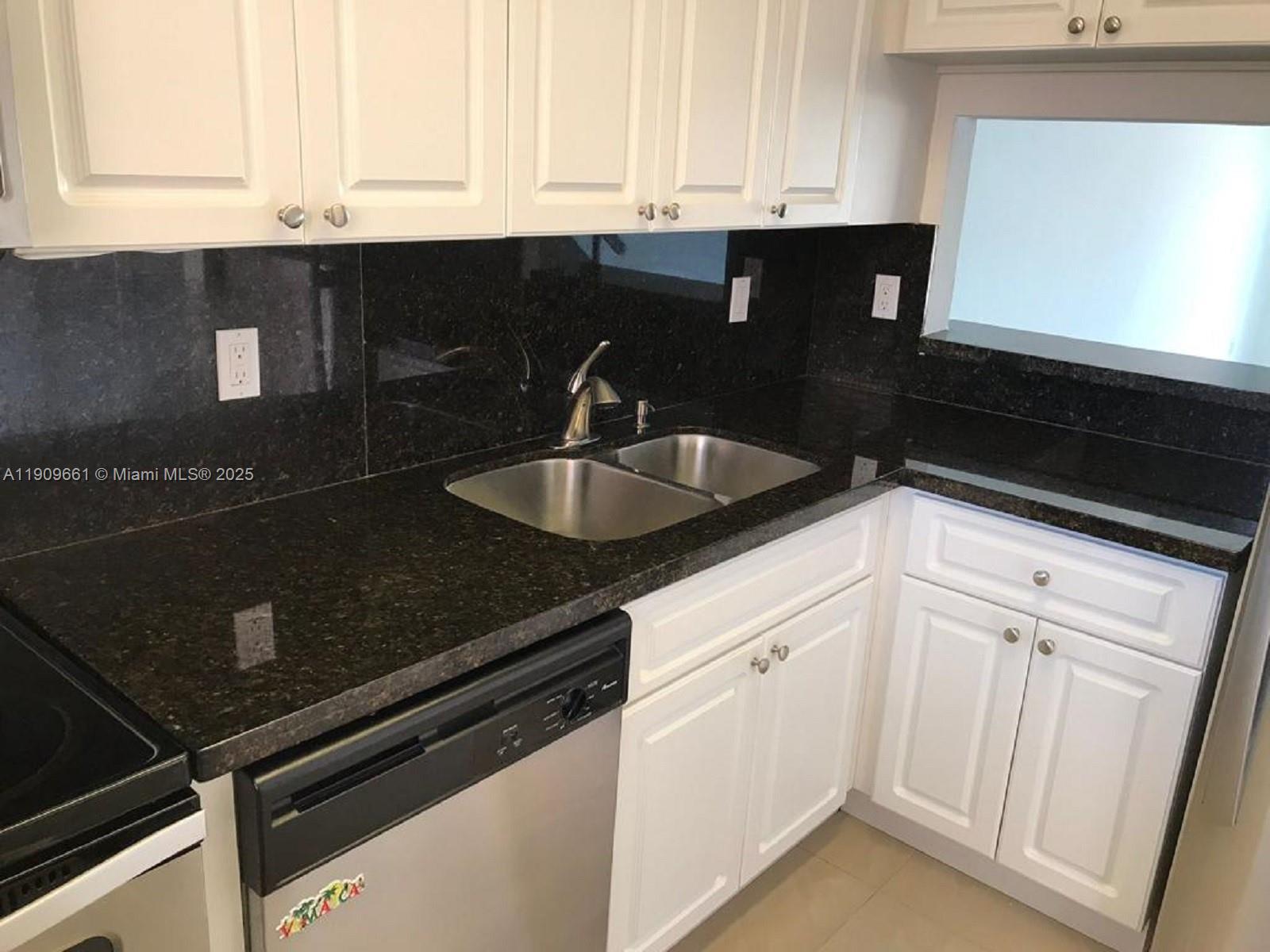 1100 West 35th Street, Unit 27 Hialeah, FL 33012 - Photo 4 of 24 a kitchen with granite countertop white cabinets and sink