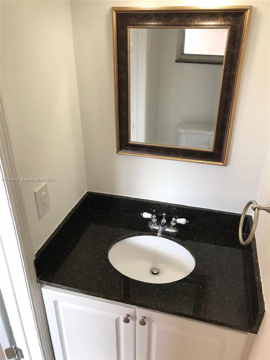 1100 West 35th Street, Unit 27 Hialeah, FL 33012 - Photo 10 of 24 a bathroom with a sink and a mirror