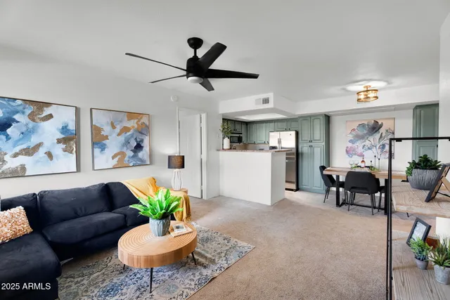 a living room with furniture and a chandelier