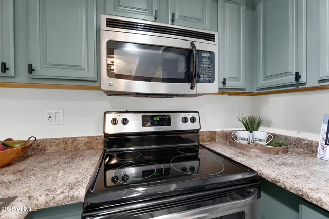 a kitchen with granite countertop a refrigerator and a sink
