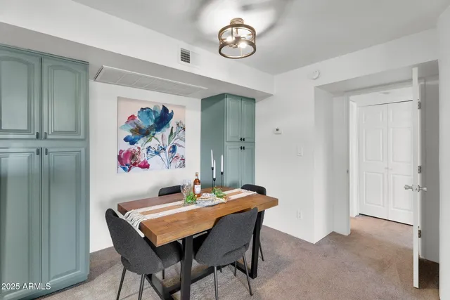 a view of a dining room with furniture and a chandelier