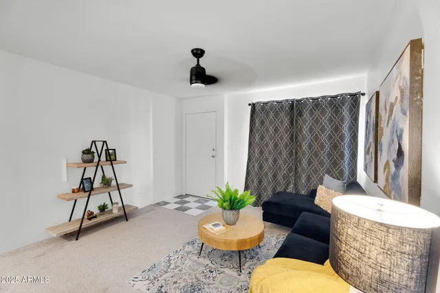 a living room with furniture and flowers