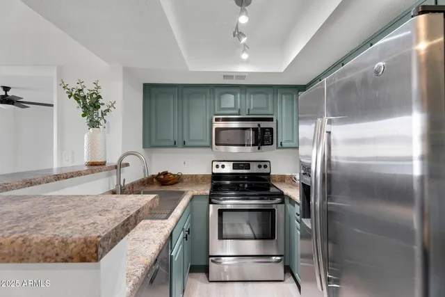 a kitchen that has a sink and a stove top oven